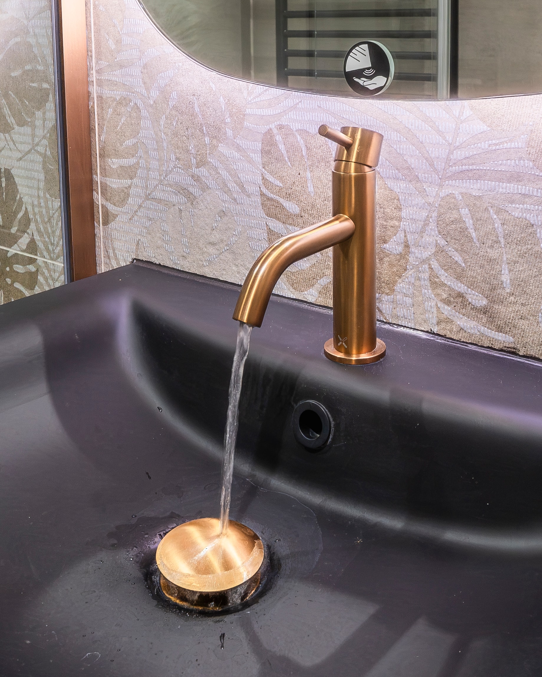 Black basin brushed copper tap