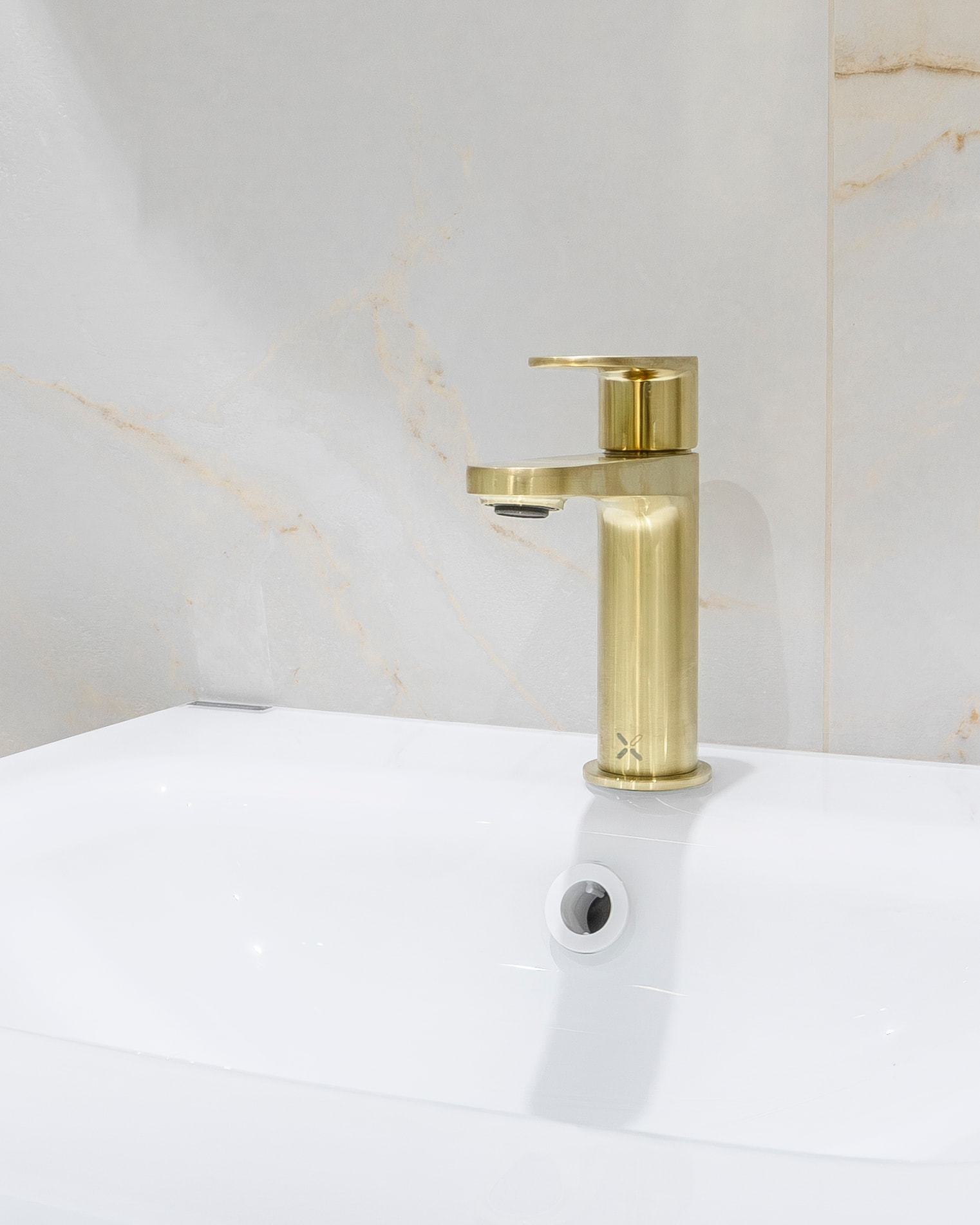 Gold tap white basin