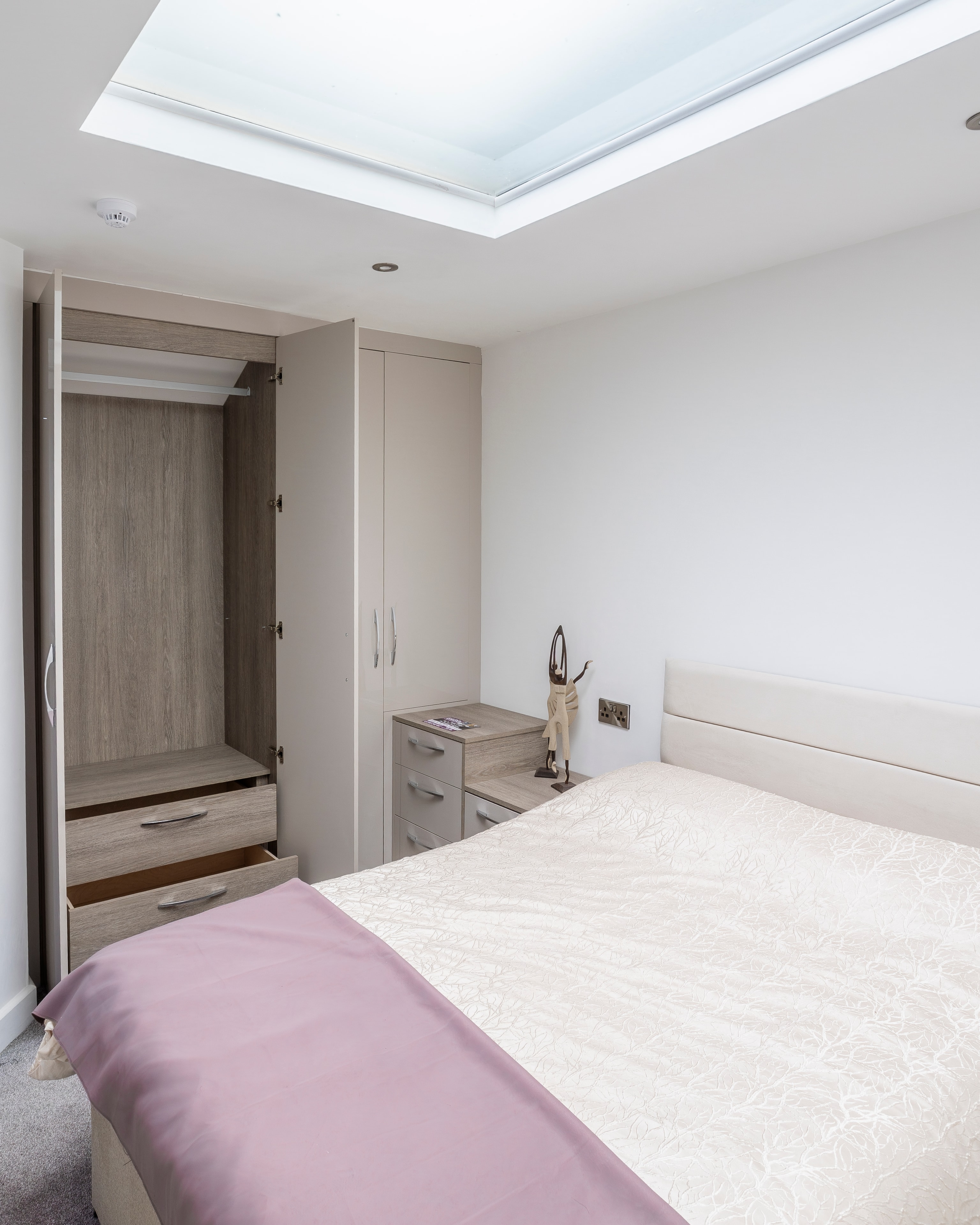 Pastel grey bedroom with pink accents